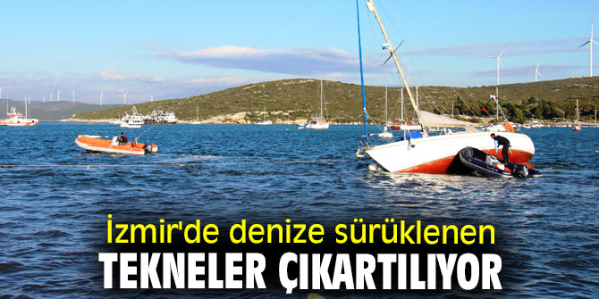 İzmir'de denize sürüklenen tekneler çıkartılıyor