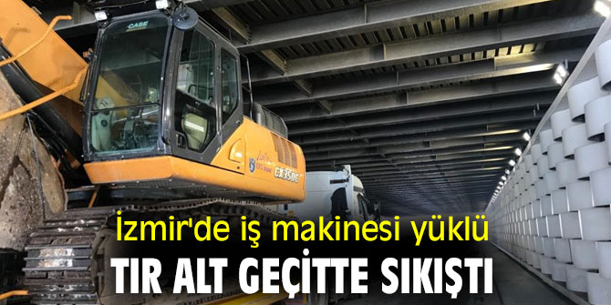 İzmir'de iş makinesi yüklü tır alt geçitte sıkıştı