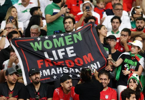 iran-fans-hold-a-banner-reading-women-life-freedom-inside-the-stadium-during-the-match-paul-childsreuters-1.webp