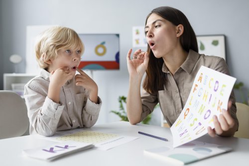 woman-doing-speech-therapy-with-little-blonde-boy.jpg