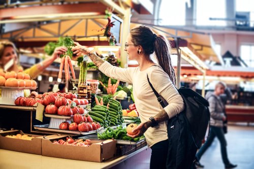 beatiful-pensive-girl-glasses-is-buying-fresh-carrots-local-farmer-s-market-1.jpg