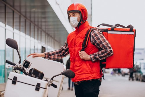 food-delivery-boy-driving-scooter-with-box-with-food-wearing-mask.jpg